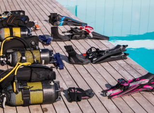 An image of a diver wearing essential scuba diving gear, ready to learn to dive