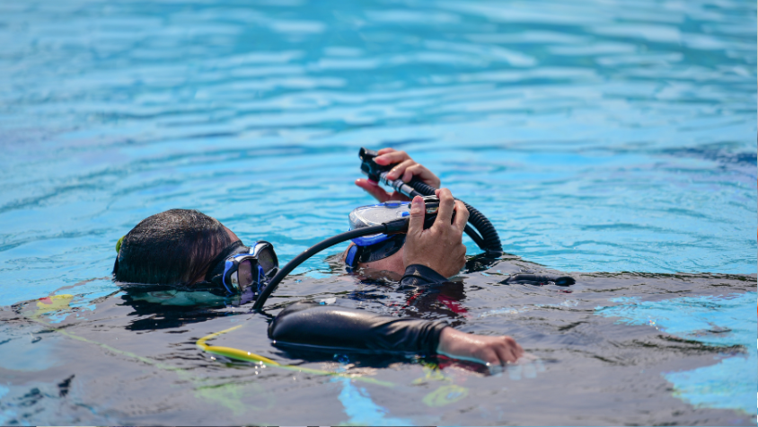 A group of certified divers mastering skill demonstrations and rescue techniques