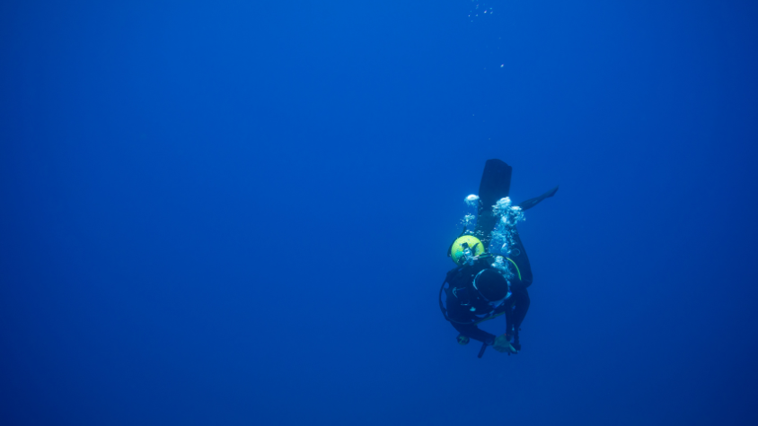 Diving in SPAIN diver diving into the blue fuerteventura canary islands